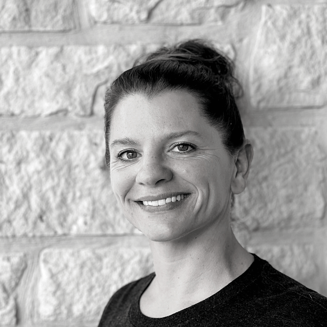 Co-Founder Sarah Head Shot in black & white against white rock wall - Wag Trendz