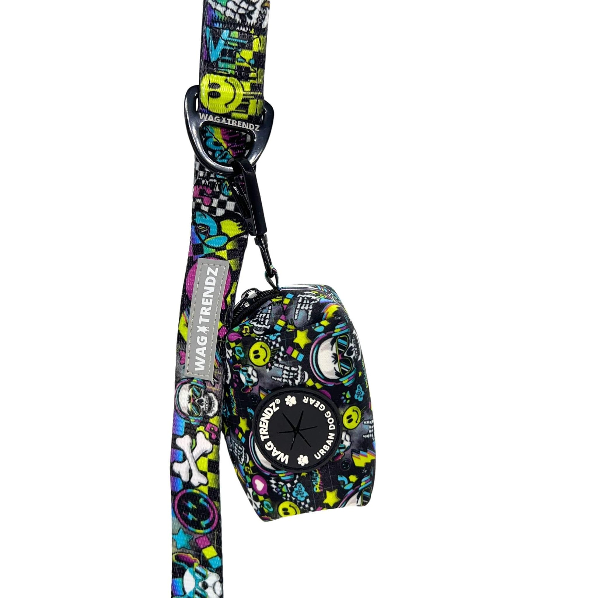 Dog Poop Bag Holder - Skull Society with multicolored graphics in yellow, blue, purple with black background - attached to the matching leash - against solid white background - Wag Trendz