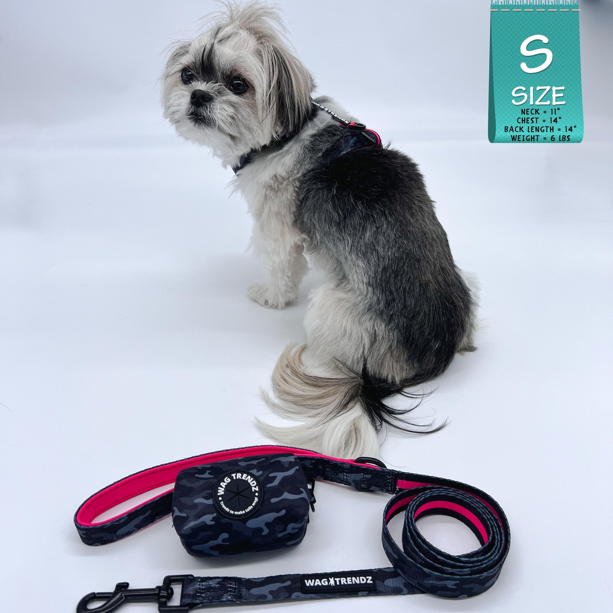 H Dog Harness - Roman Dog Harness - Shih Tzu mix wearing small black and gray camo harness with bold hot pink accents and matching dog leash and poop bag holder - against a solid white background - side view - Wag Trendz