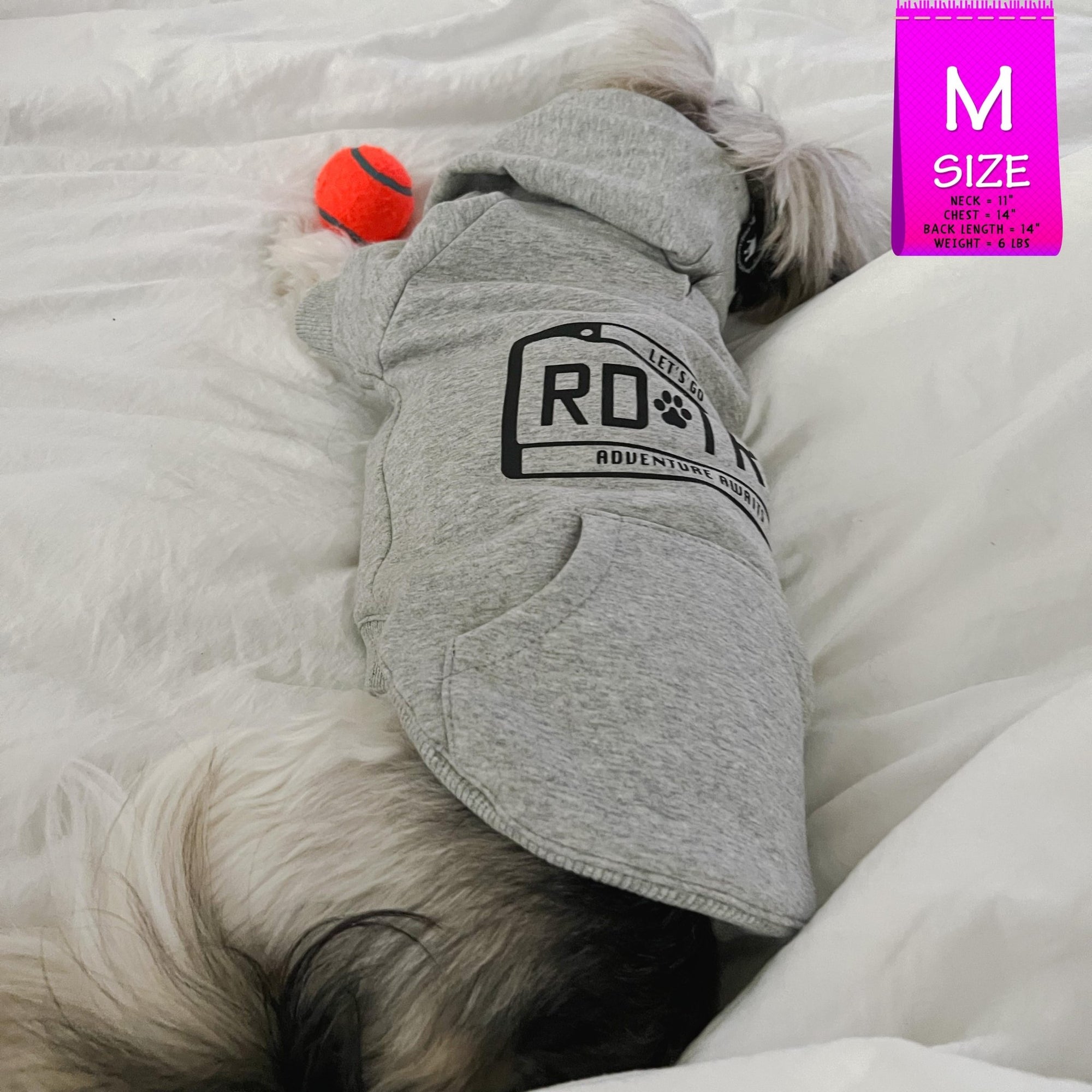 Dog Hoodie - Hoodies For Dogs - Shih Tzu mix wearing &quot;Road Trip&quot; License Plate design in gray - back view - laying on the bed sleeping with orange tennis ball toy - Wag Trendz