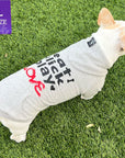 Dog hoodie - Hoodies For Dogs - French Bulldog wearing Valentine "eat lick play LOVE" graphic dog hoodie - back view gray with black lettering and red accents on the hoodie - standing outdoors in the grass - Wag Trendz