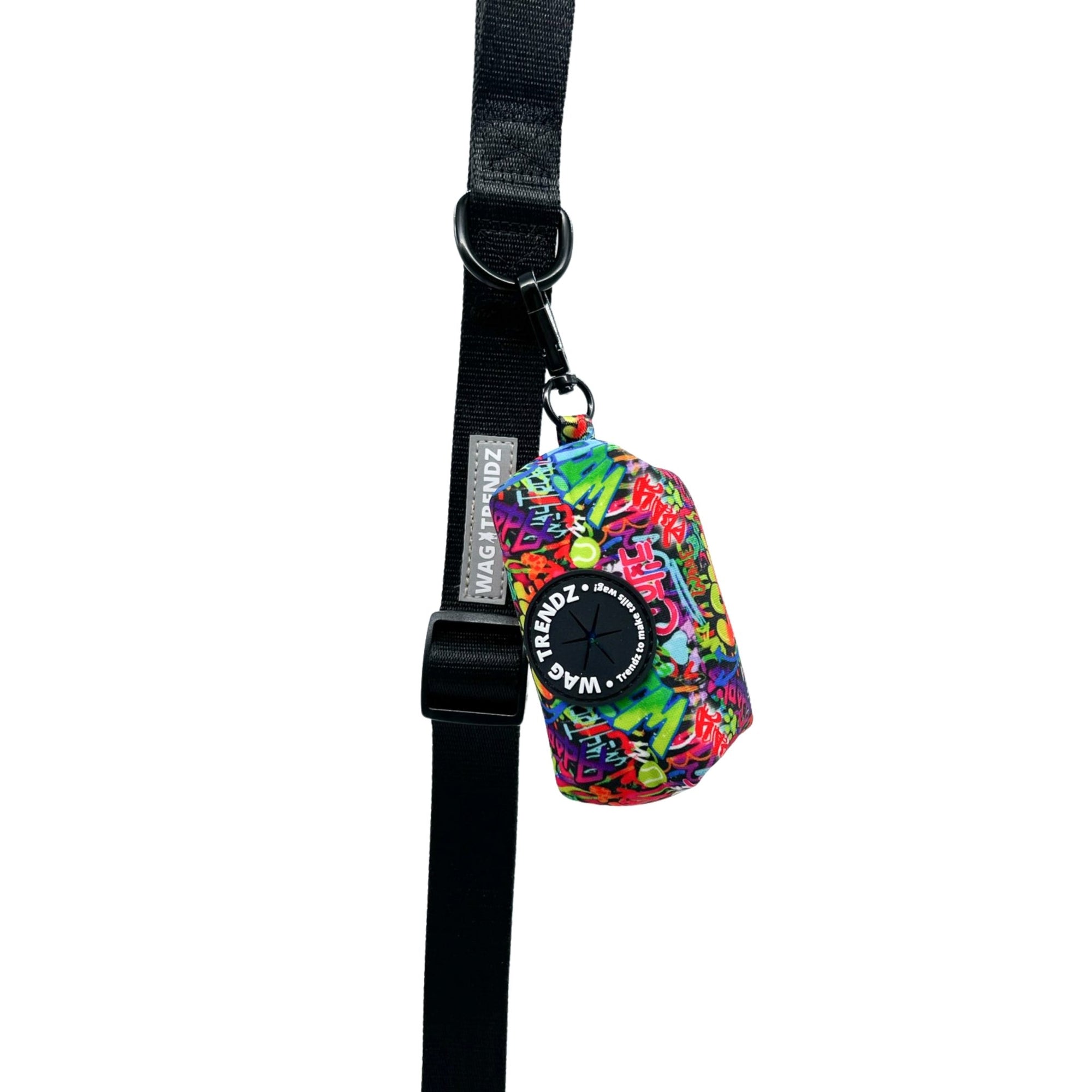 Dog Poo Bag Holder - multi-colored street graffiti hanging on solid black dog leash - against white background - Wag Trendz