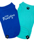 Dog T-Shirt - "Stay Pawsitive" - Royal Blue and Teal dog t-shirt - Stay Pawsitive lettering in white on blue t-shirt and a paw print emoji in black on chest of teal t-shirt - against solid white background - Wag Trendz