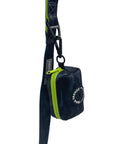 Dog Poo Bag Holder - black and gray camo design with a hi-vis zipper and black rubber logo dispenser on front - hanging from a matching leash against a solid white background - Wag Trendz